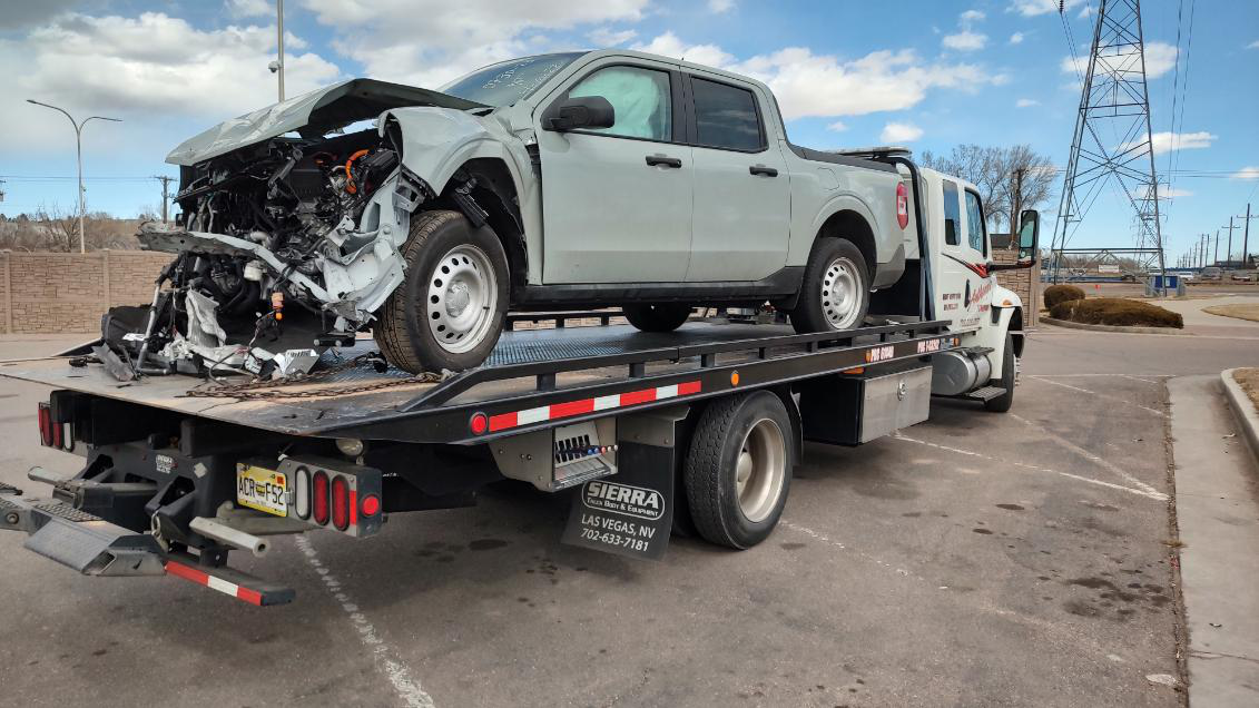 Towing Car Carrying a Damaged Truck