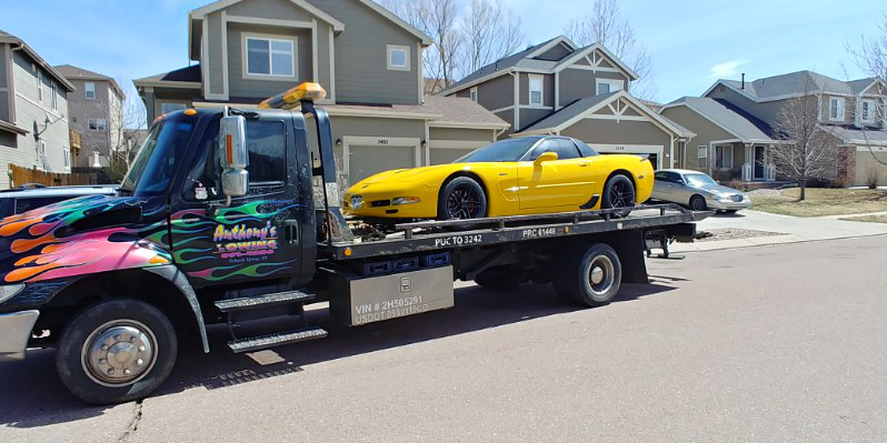 A yellow car gets assistance, ensuring a stress-free and smooth travel experience with Anthony's Towing.