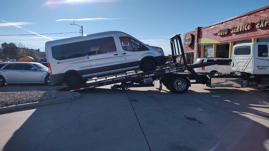 A silver minivan being efficiently towed by Anthony's Towing during the holidays.