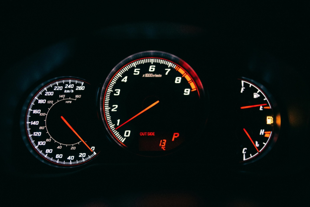  A dashboard shows an empty fuel tank on the gauge, highlighting the necessity of maximizing fuel efficiency for an uninterrupted driving experience.