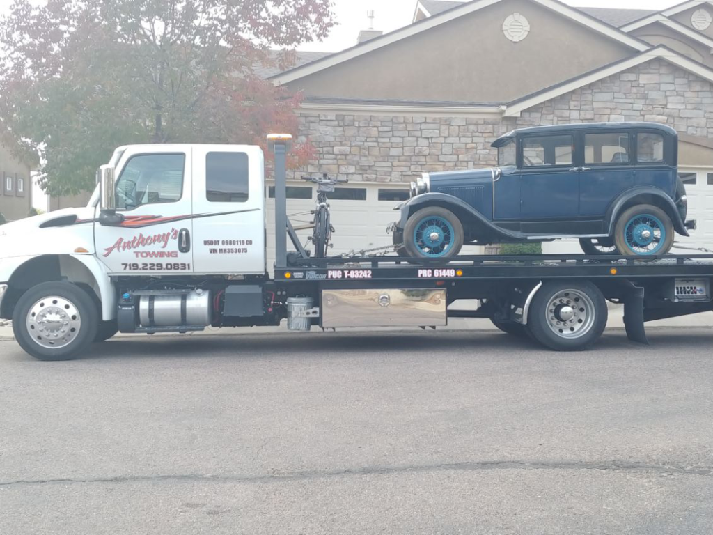  A classic vintage car loaded onto an Anthony's Towing tow truck, a seamless rescue preserving the elegance of the timeless automobile.