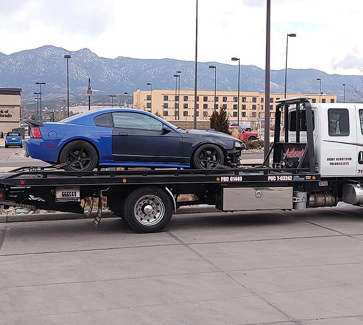 A tow truck with a car