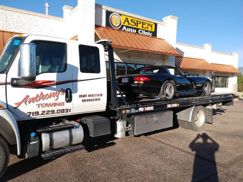  A black convertible car brought to auto clinic by Anthony's Towing LLC tow truck 